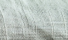 Close-up of a sea-green linen weave: tight plain weave, irregular yarn, washed.